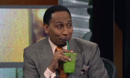 Person sipping a drink lazily while relaxing.